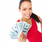 Cheerful young lady holding cash and smiling